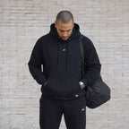 POLERÓN BOXY FIT NEGRO ALGODÓN HOMBRE - VISTA FRONTAL CON BOLSO